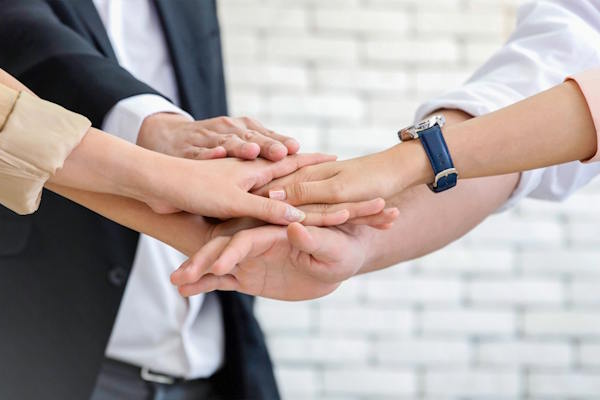 close up business team of young man and woman showing unity with